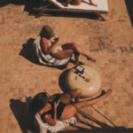 Two guests relax on the sunny terrace between surfing and pottery sessions in Imsouane,