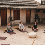 Joint yoga session on the terrace of the Tayourt during the pottery and surf retreat in Imsouane, Morocco