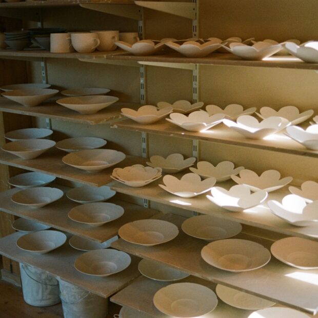 Idakumori ceramic studio shelves, full of handmade porcelain plates and bowls by Lilly Haas