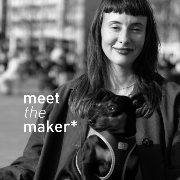 Black and white portrait of ceramic maker and db pottery member Laura Hasenöhrl holding a small dog, with 'meet the maker*' text overlay